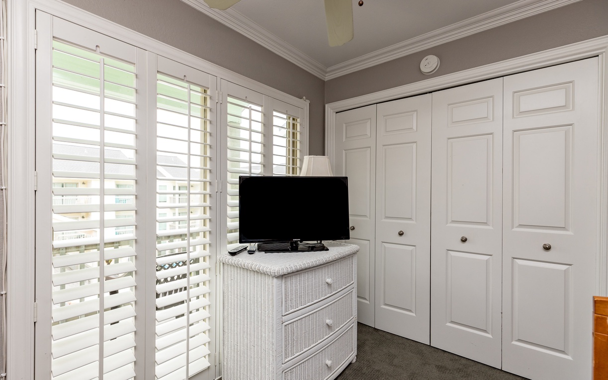 Relax in your bright bedroom with plantation shutters, flat-screen TV, and generous storage space for all your vacation essentials.