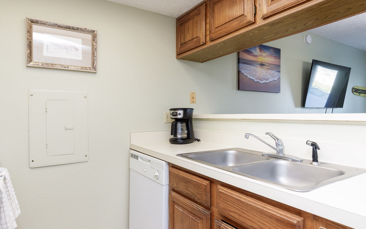 Your fully equipped kitchen features warm wood cabinets, a coffee maker for morning brews, and a dishwasher for easy cleanup.