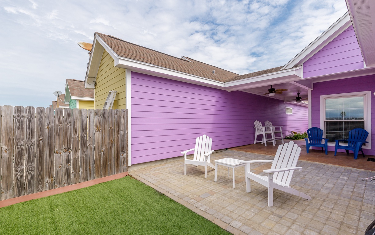 Relax in your private backyard oasis with comfortable seating and vibrant coastal charm.