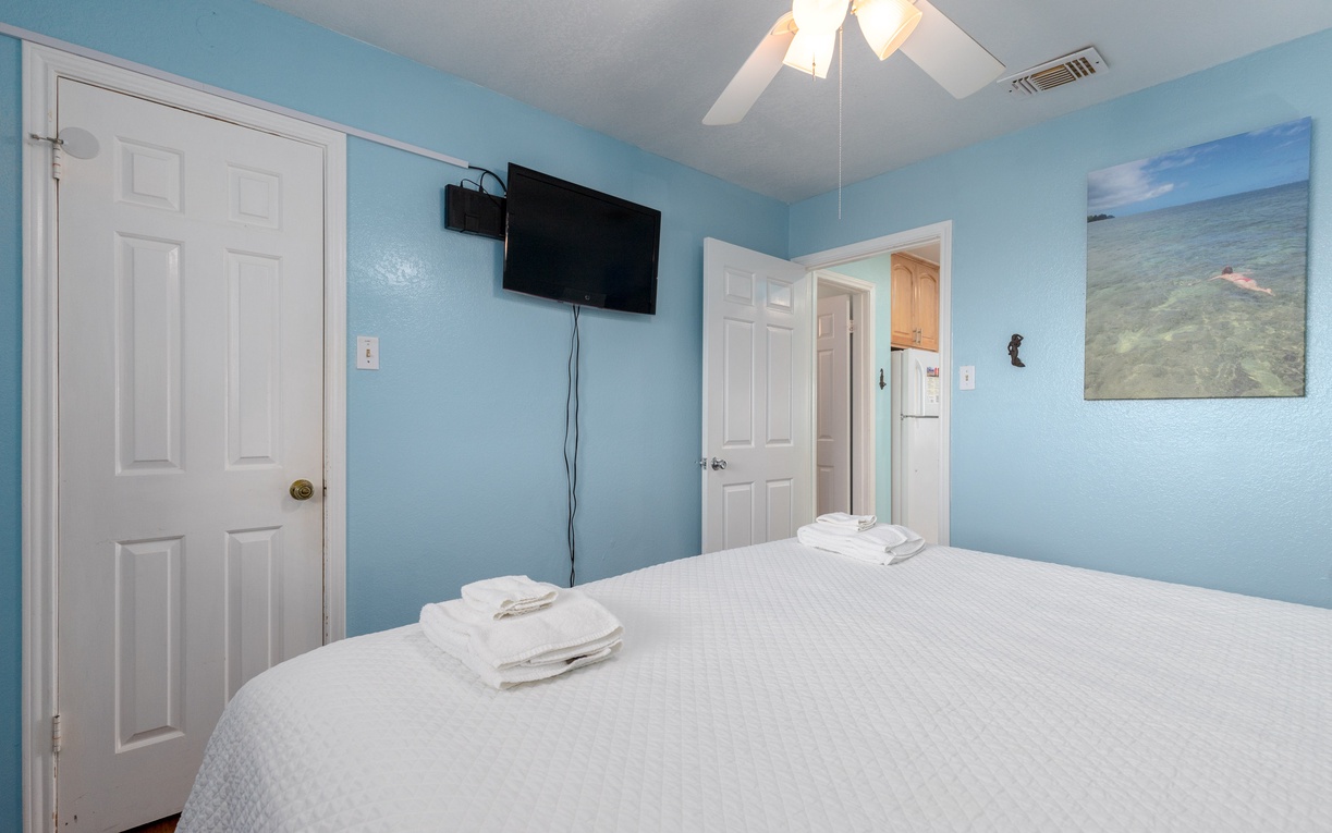Drift into peaceful sleep in your ocean-themed bedroom, where soft blue walls and crisp white linens create a serene coastal retreat.