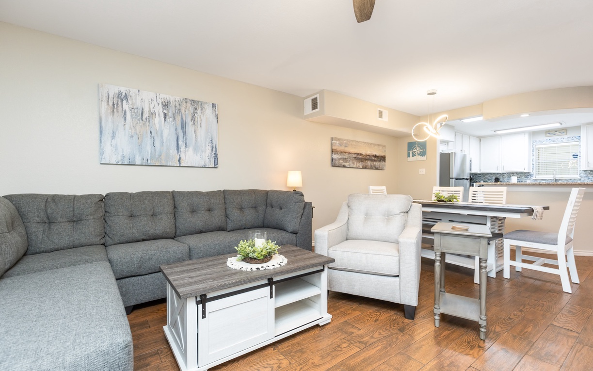 Relax in your spacious living area with plush sectional seating, then enjoy meals at your dining table overlooking the modern kitchen.