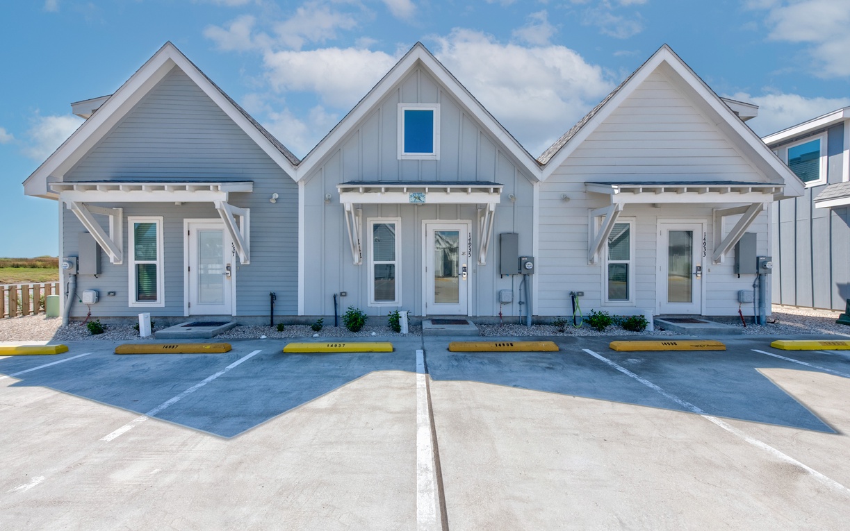 Charming coastal-style cottages with convenient parking spaces right at your doorstep for easy arrival and departure.