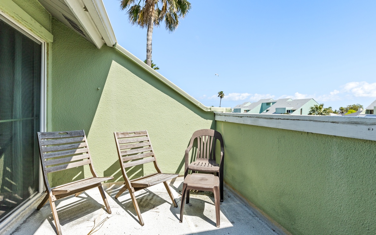 Soak up Florida sunshine on your private balcony with comfortable seating and tropical palm views.