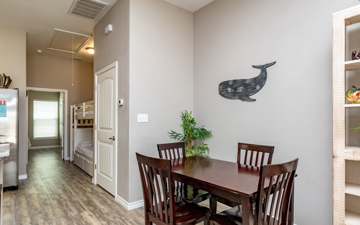 Gather around your cozy dining table for memorable meals with loved ones in this thoughtfully designed space.
