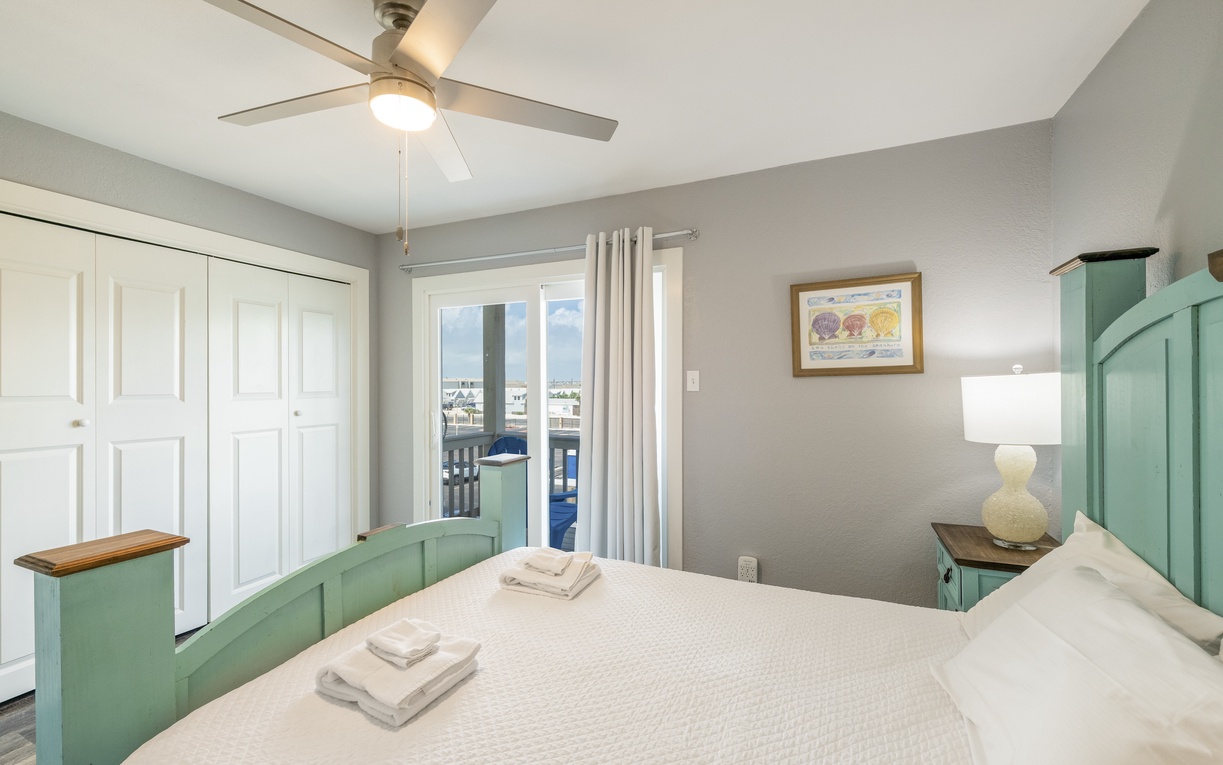 Your peaceful guest bedroom sanctuary features a cozy queen size bed and private balcony.