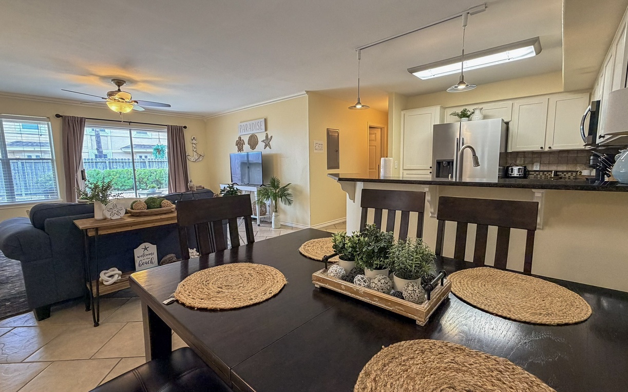 Gather around this inviting dining table where your family meals come alive, perfectly positioned between the cozy living room and fully-equipped kitchen.