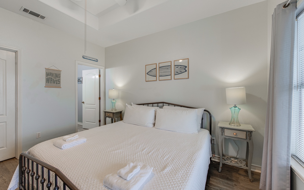 Sink into crisp linens and coastal charm in this serene bedroom, where soft lighting and nautical touches create your perfect retreat.