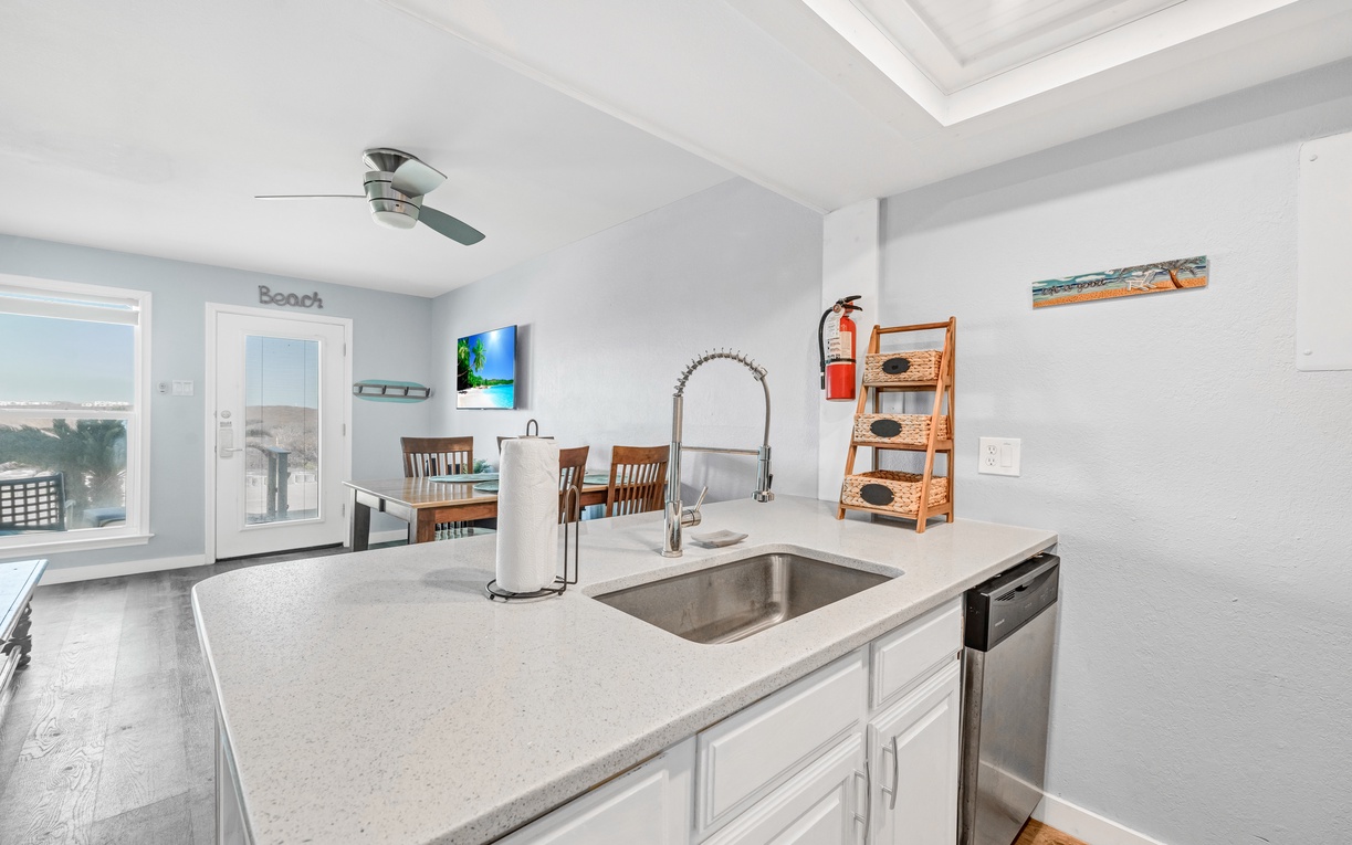 Cook your favorite meals in this modern kitchen with granite counters and stainless appliances while ocean views inspire your culinary adventures.