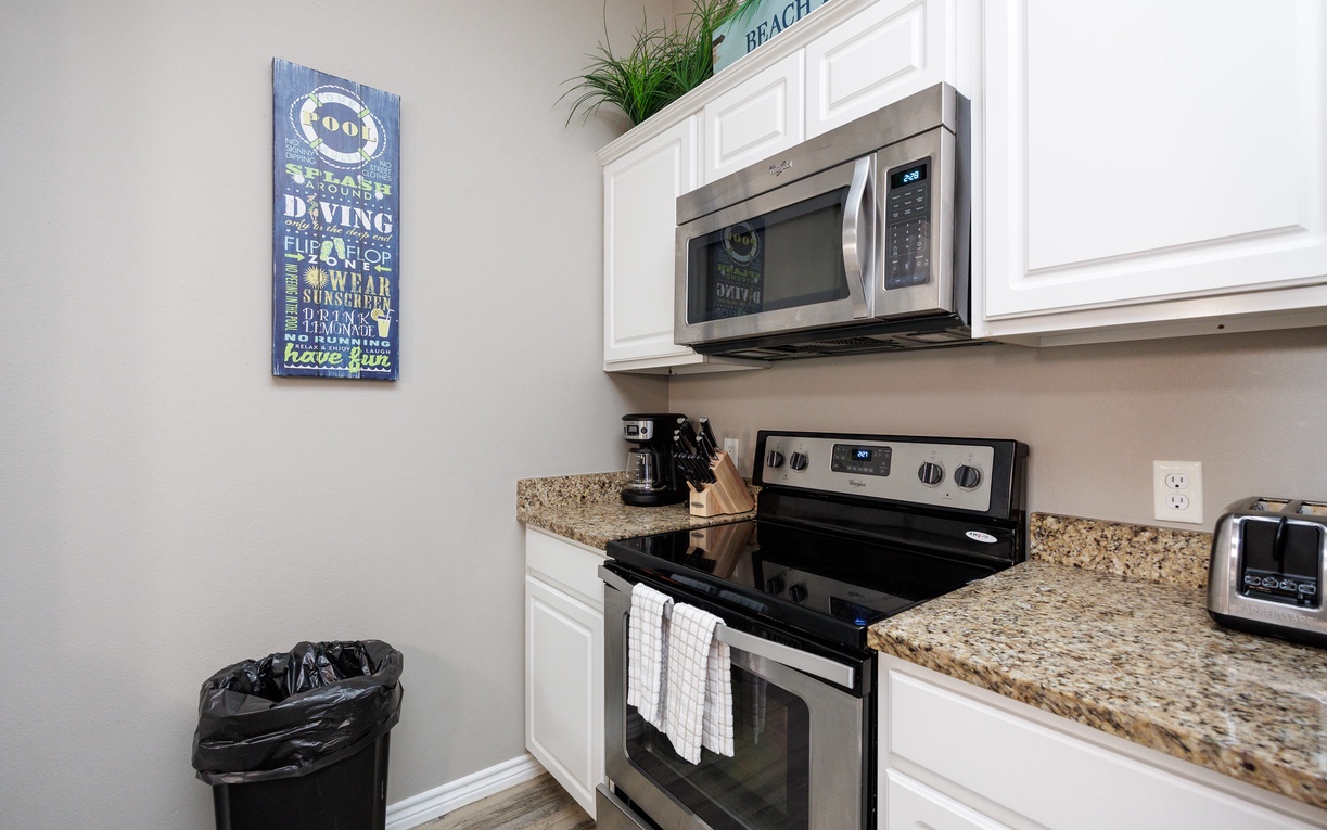 Your fully equipped kitchen features granite counters, stainless appliances, and cheerful beach decor—everything you need to prepare delicious meals during your stay.