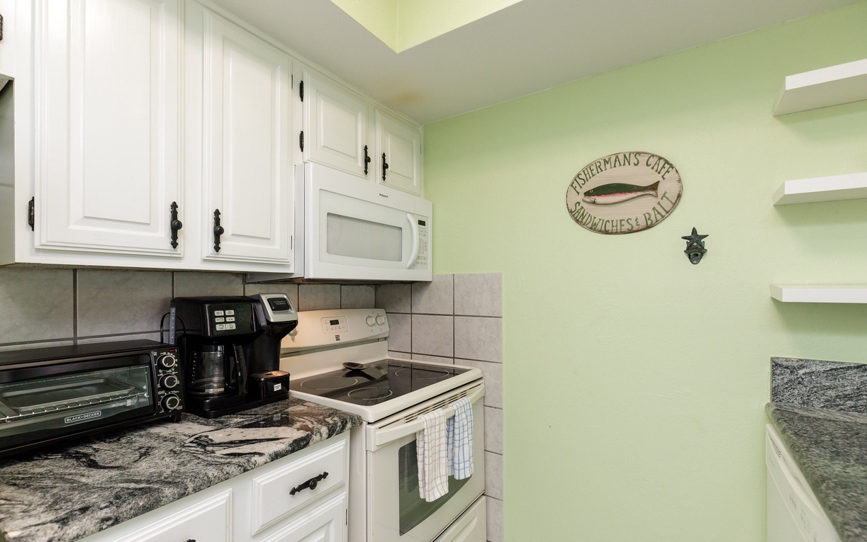 Your coastal-themed kitchen awaits with full appliances and charming nautical touches, perfect for preparing fresh catches.