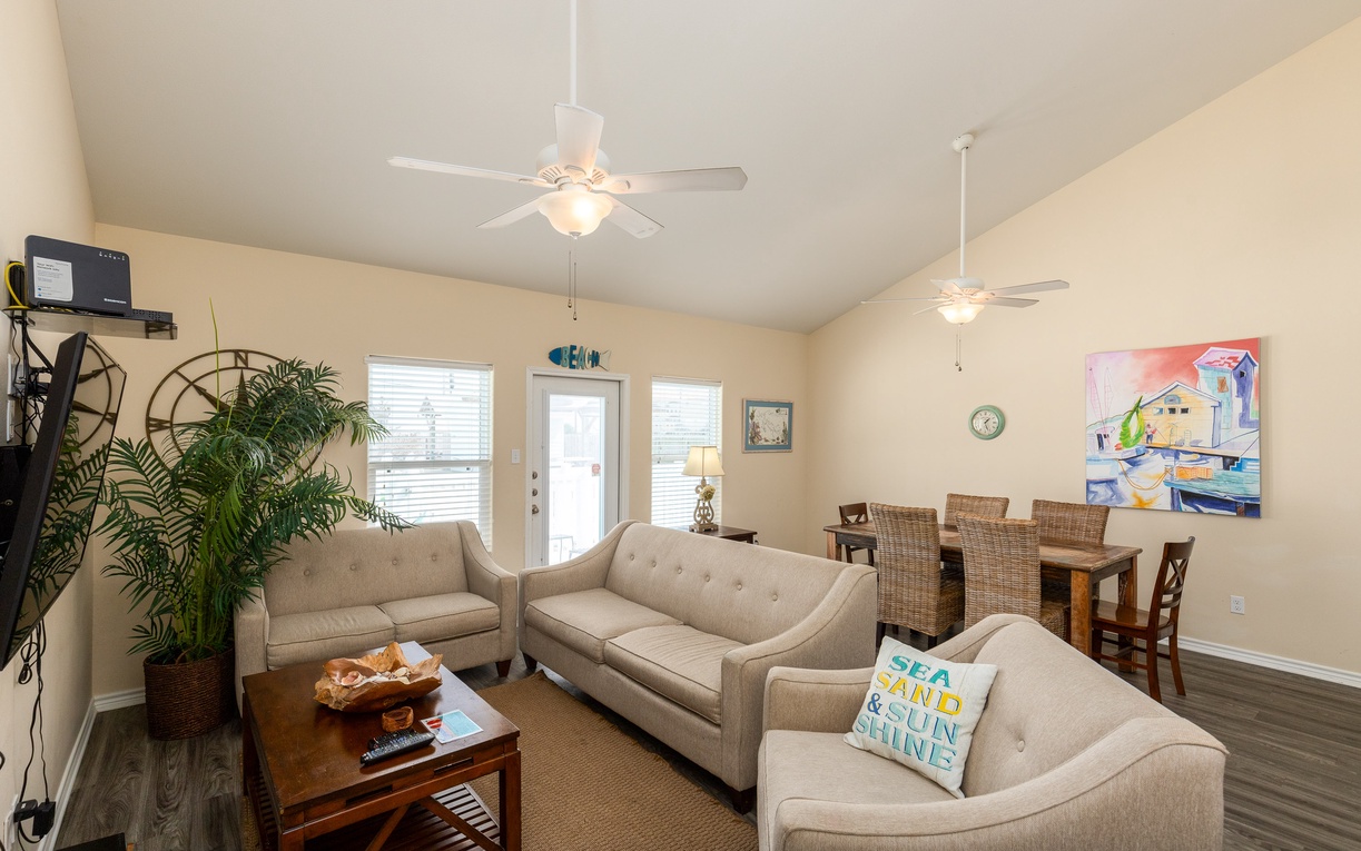 Relax in your bright open living space with comfy seating, coastal charm, and dining for six.