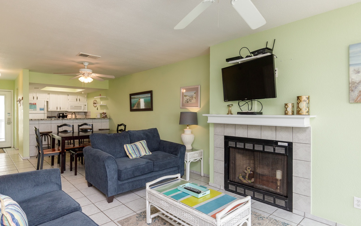 Unwind in your cozy living space with comfortable seating, warm fireplace, and entertainment center for perfect vacation evenings.