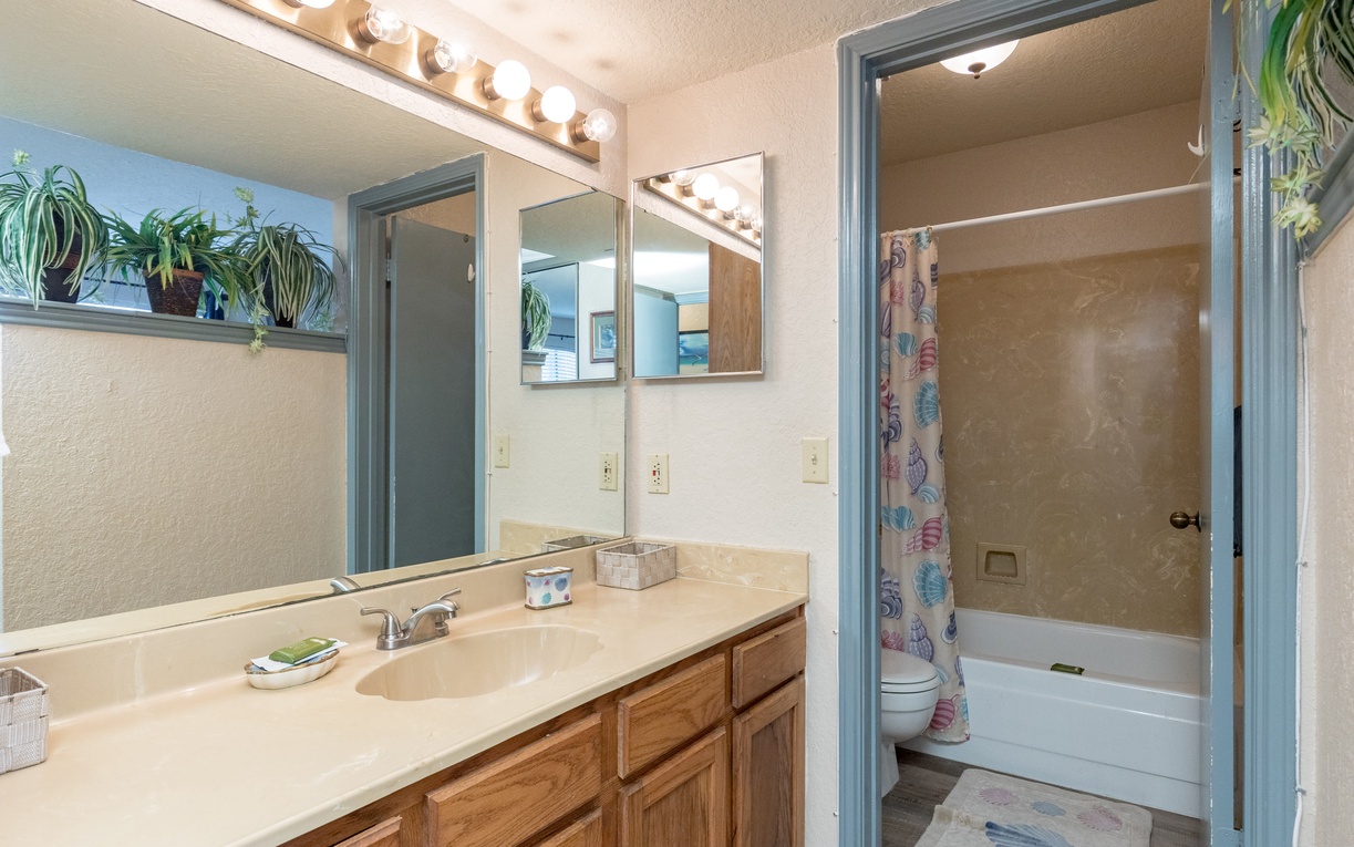 Freshen up in your bright, well-lit bathroom with a vanity mirror surrounded by Hollywood-style bulbs and a relaxing shower-tub combo.