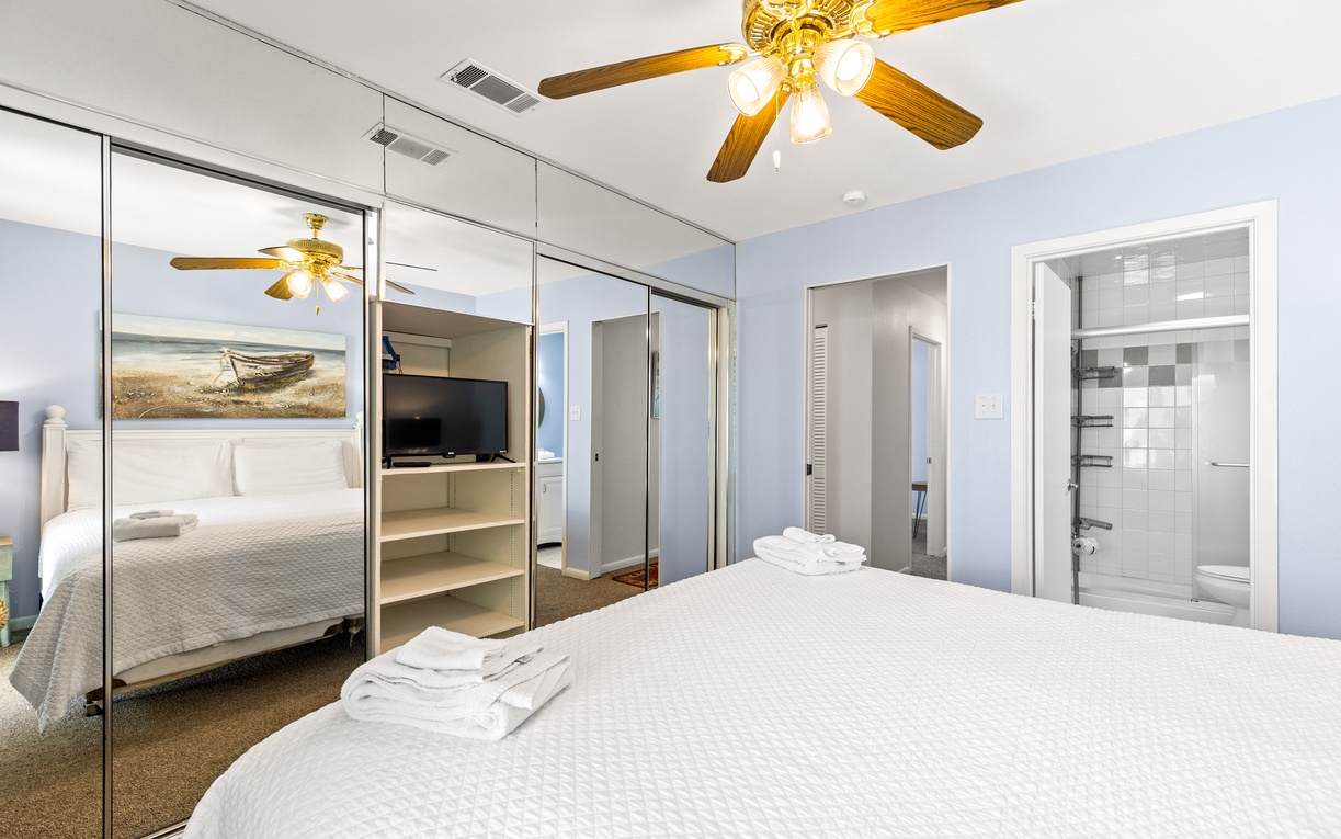 Relax in your spacious bedroom with mirrored closets, ceiling fan, and private ensuite bathroom—fresh towels await your arrival.