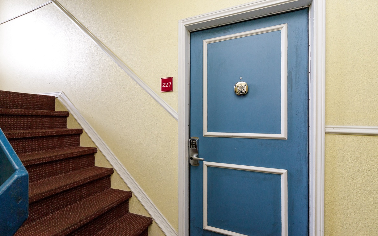Your private retreat awaits behind this charming blue door, perfectly positioned for easy access with the staircase right nearby.