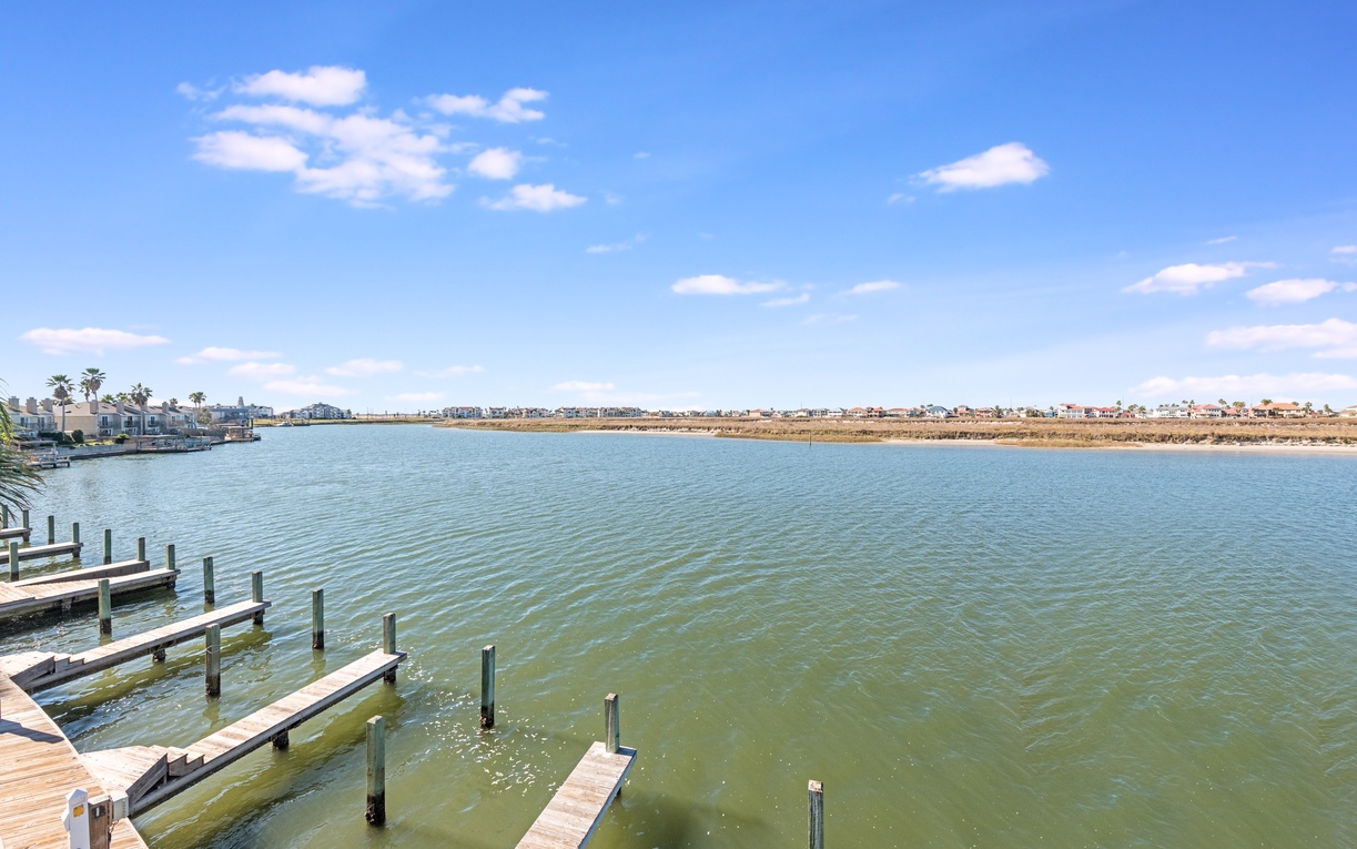 Waterfront community with rental docks stretching across calm waters under clear blue skies.