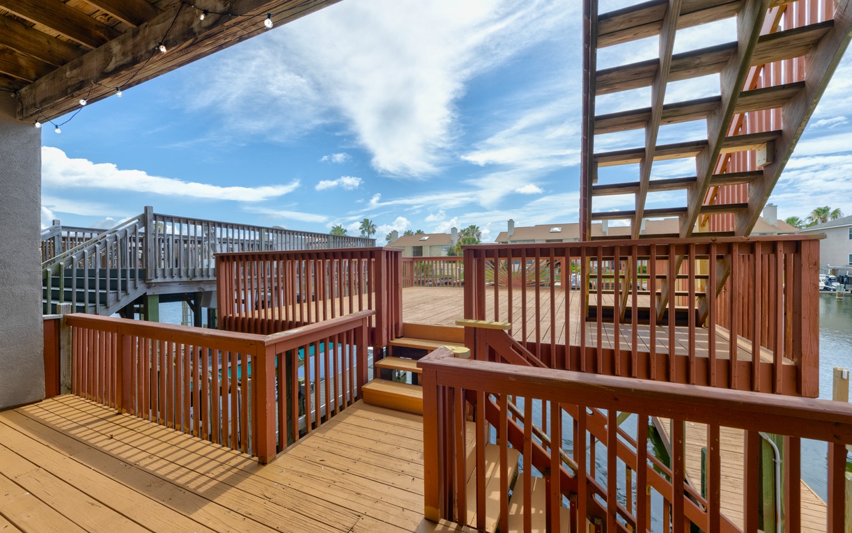 Soak in the sunshine on your private waterfront deck, where rich wood tones frame tranquil canal views and endless blue skies invite peaceful mornings and laid-back afternoons.