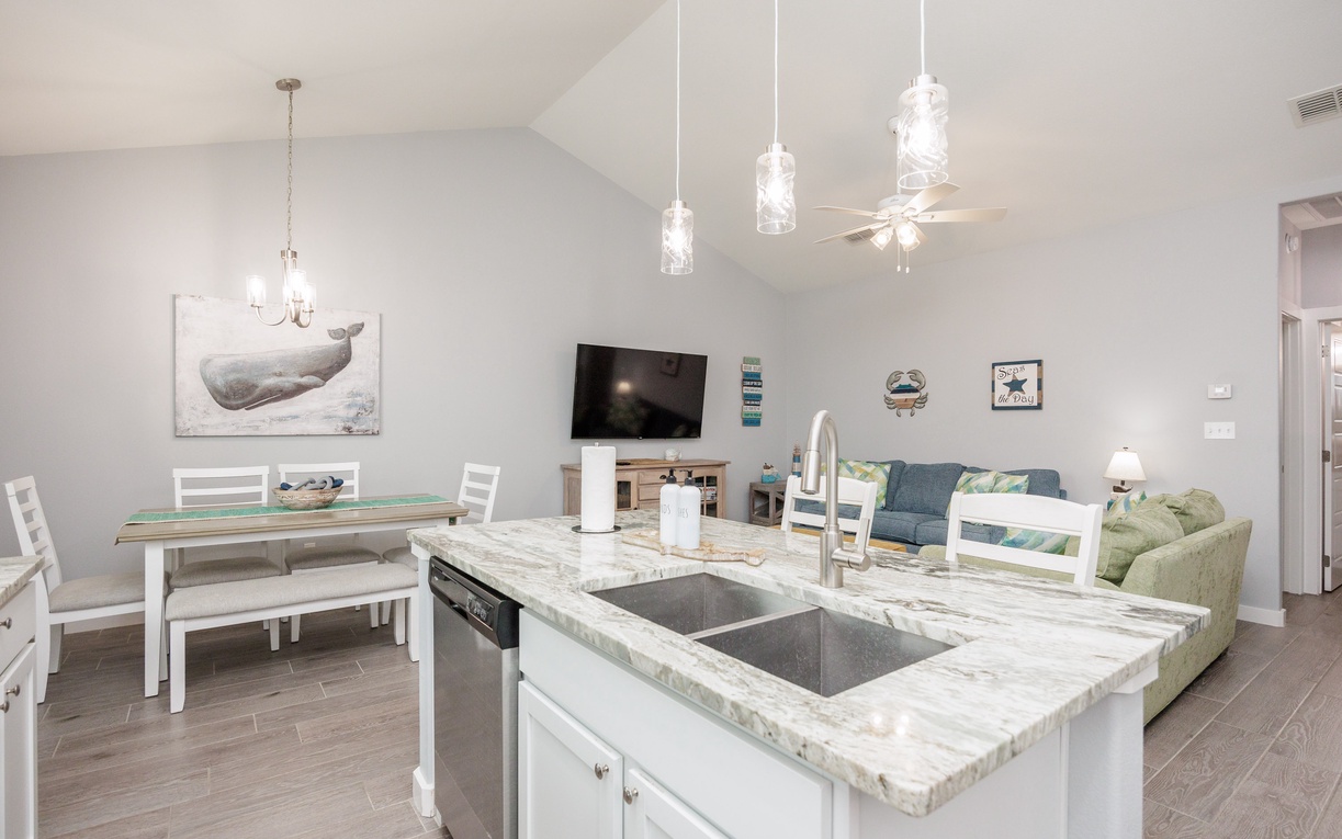 Your open-concept space flows from kitchen island to living room, perfect for gathering while you prepare meals and relax together.