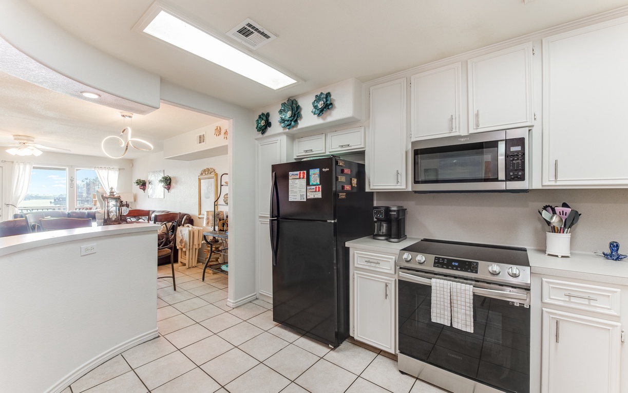 Your fully equipped kitchen awaits with modern appliances, bright skylights, and easy flow into the living space for memorable meals.