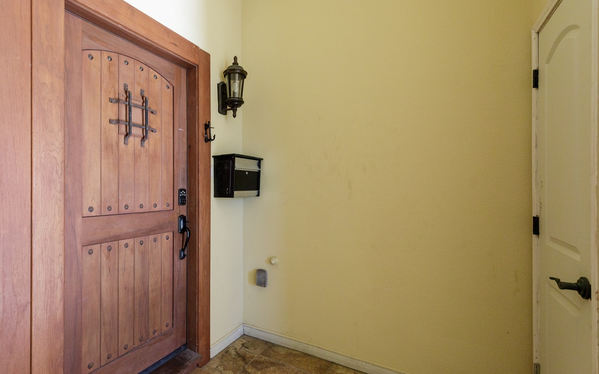 Step through your private entrance into a welcoming foyer with warm wood accents and thoughtful details that make arriving feel like coming home.