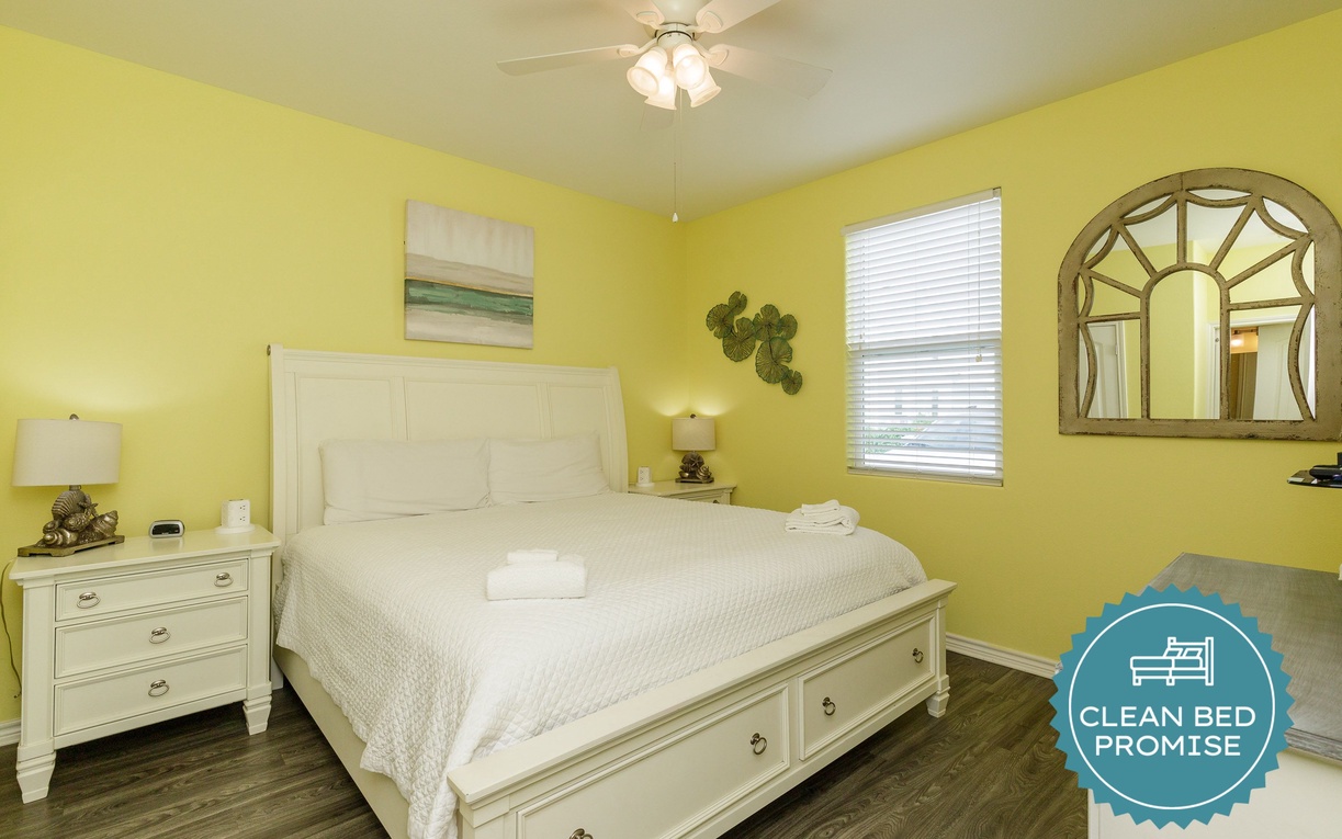 Sink into comfort with crisp white linens and cheerful yellow walls that brighten your mornings. Your peaceful retreat awaits.