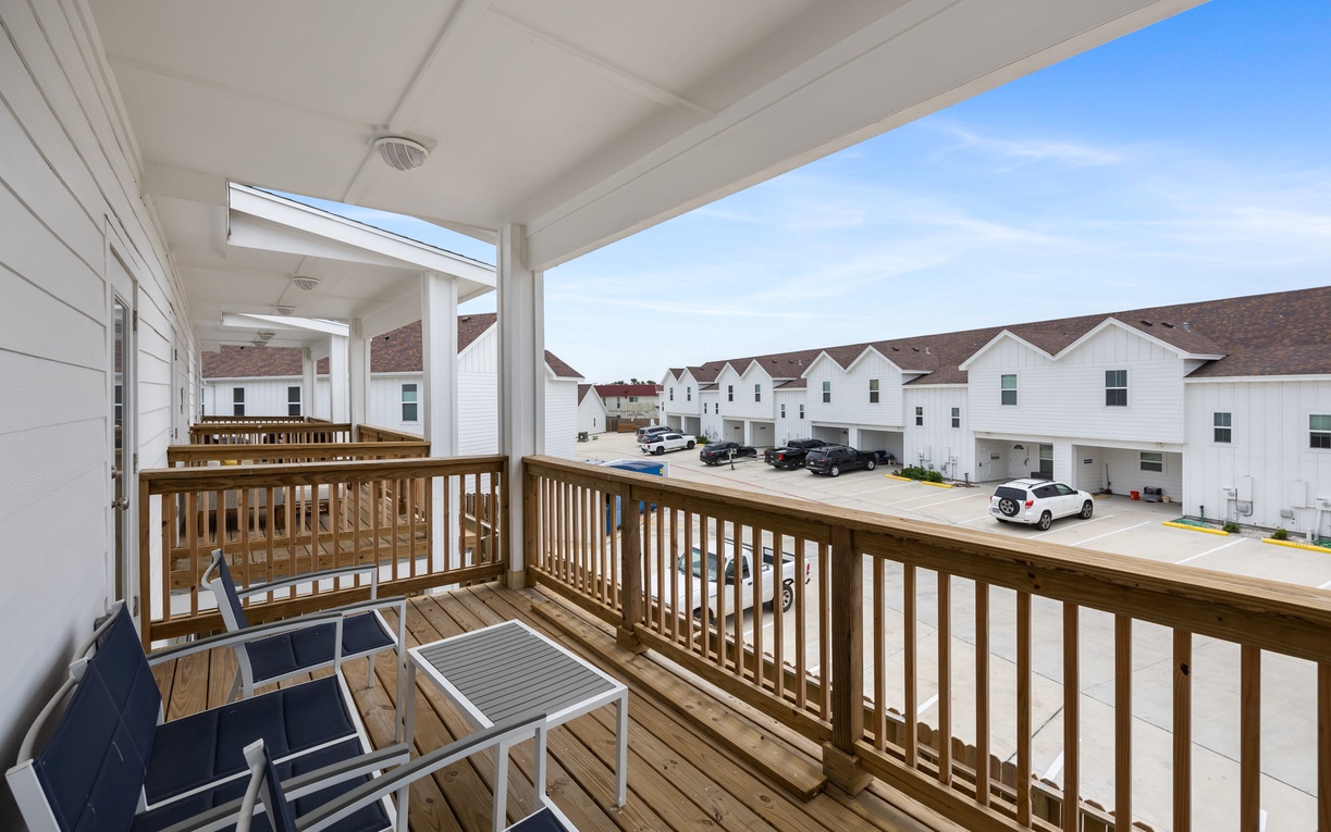 Your private balcony offers comfortable seating and peaceful views of the residential neighborhood.