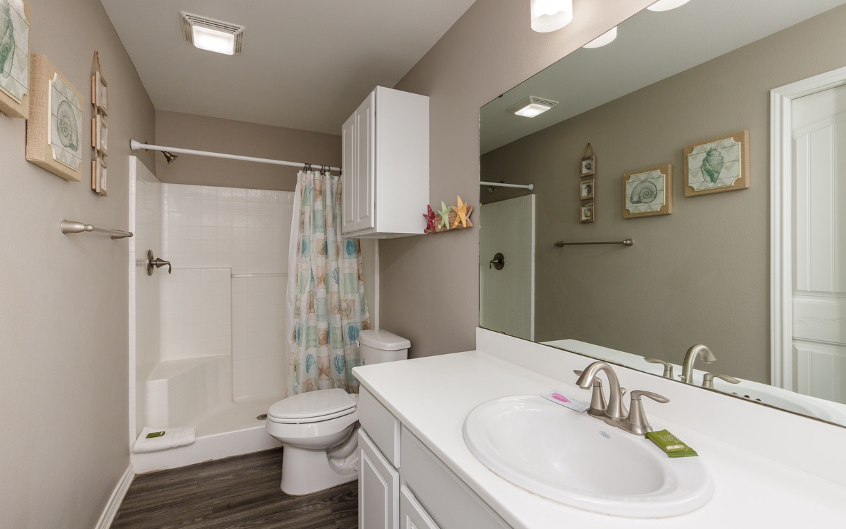 Your private bathroom offers comfort with a spacious shower, fresh linens, and coastal-inspired décor that makes you feel right at home.