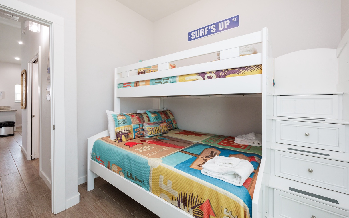 Your kids will love this fun surf-themed bunk bed with colorful bedding and plenty of storage space for all their beach adventures.