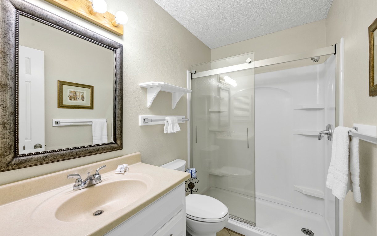 Step into your private spa-like bathroom with a spacious walk-in shower, elegant vanity, and fresh towels awaiting your arrival.