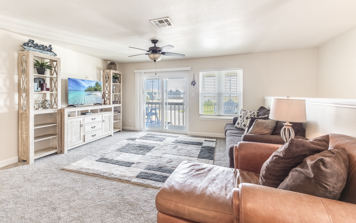 Sink into plush leather seating while enjoying your favorite shows on the large screen TV in this inviting living space.