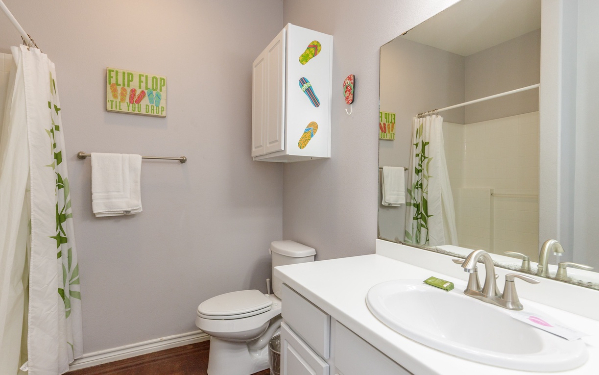 Refresh in your private bathroom with playful beach-themed decor and fresh towels waiting for you.
