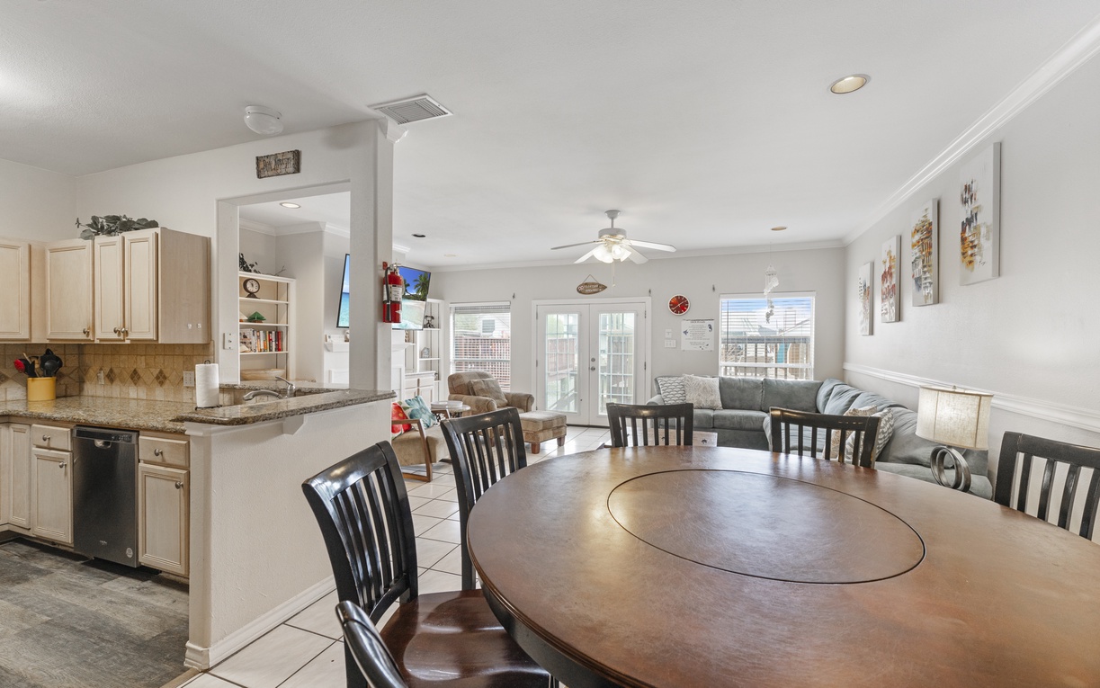 Gather around this spacious dining table for memorable meals, while the open kitchen keeps you connected to the cozy living area beyond.