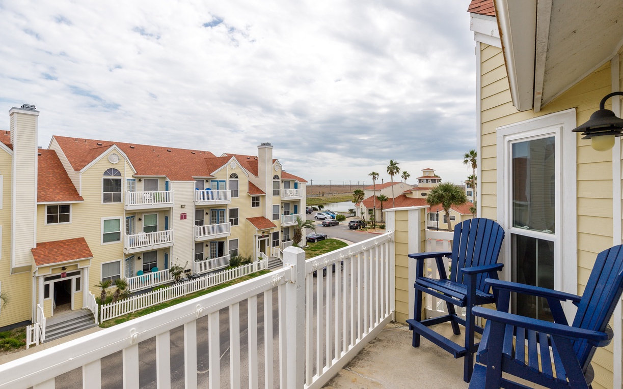 Step onto your private balcony with blue Adirondack chairs and take in the charming coastal community views.