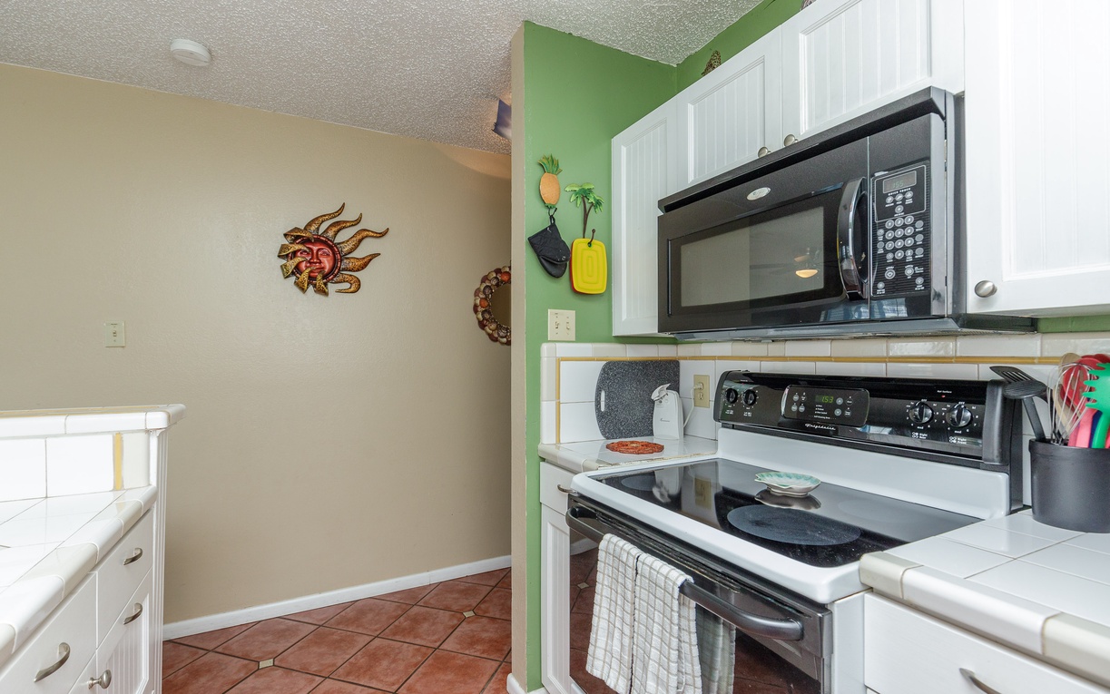 Your fully-equipped kitchen features modern appliances and vibrant touches, perfect for preparing meals during your beachside getaway.