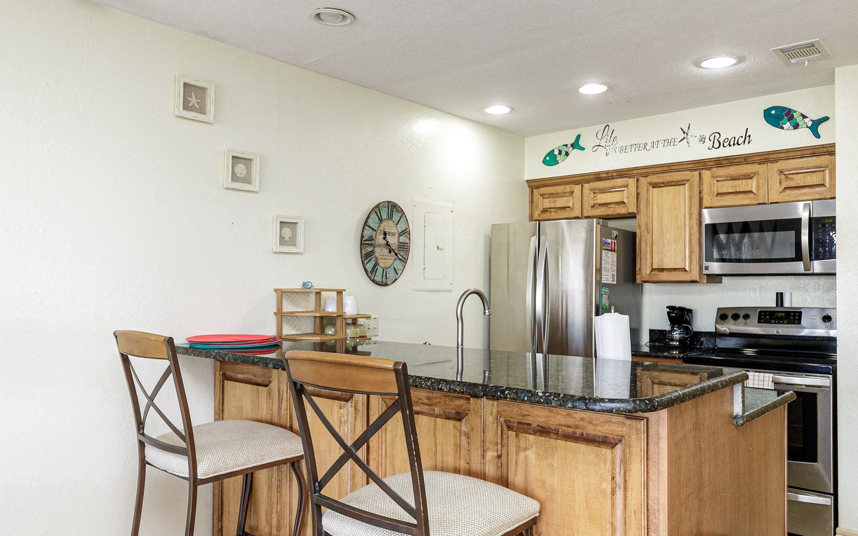 Prepare your favorite meals in this charming coastal kitchen, complete with granite counters and cheerful beach decor.