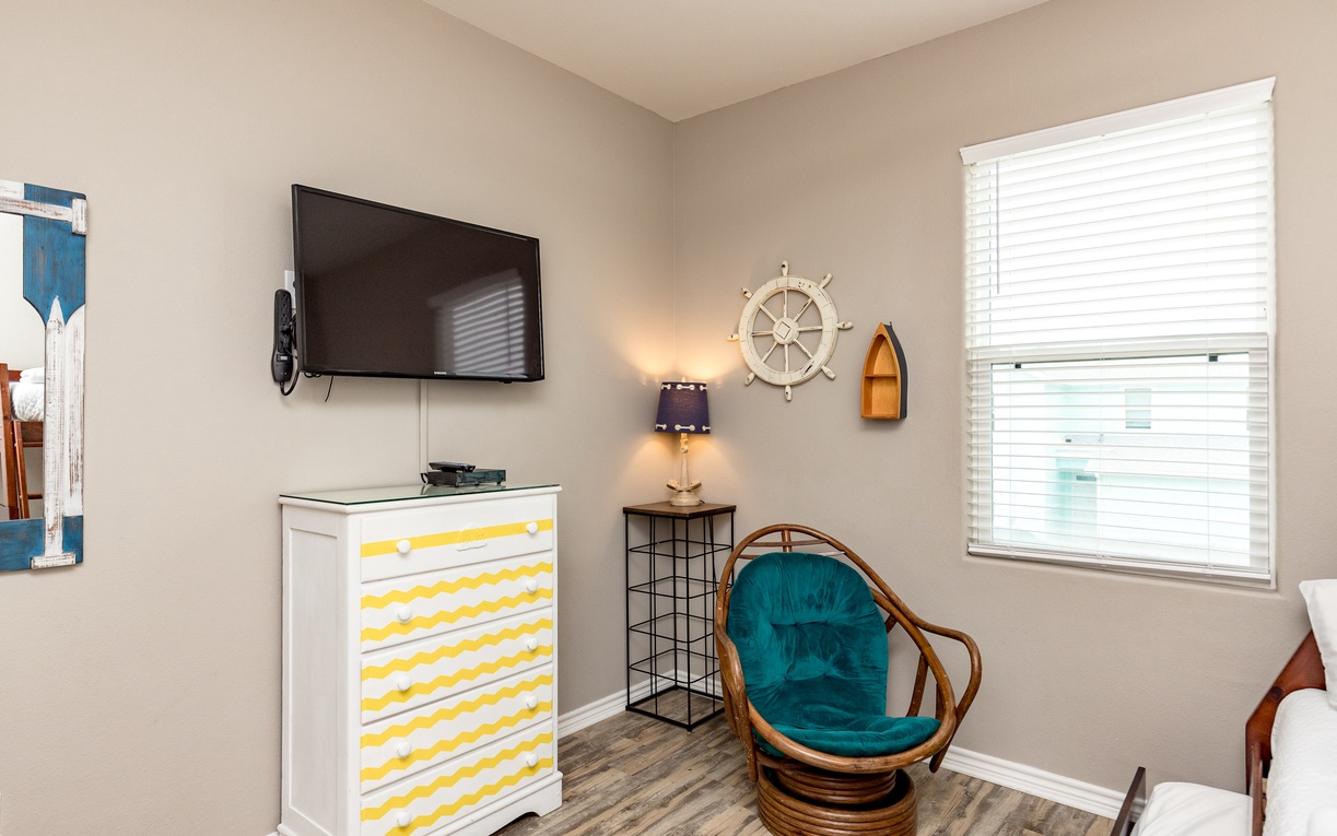 Unwind in your charming nautical-themed corner with comfortable seating, flat-screen TV, and coastal décor creating the perfect seaside retreat atmosphere.