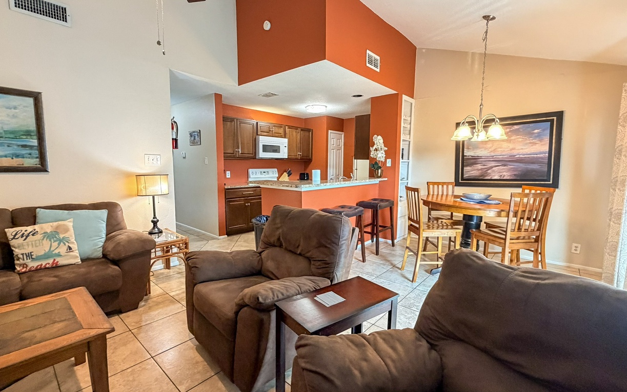Sink into plush seating and enjoy your morning coffee in this warm, open-concept space where kitchen, dining, and living areas flow together perfectly.