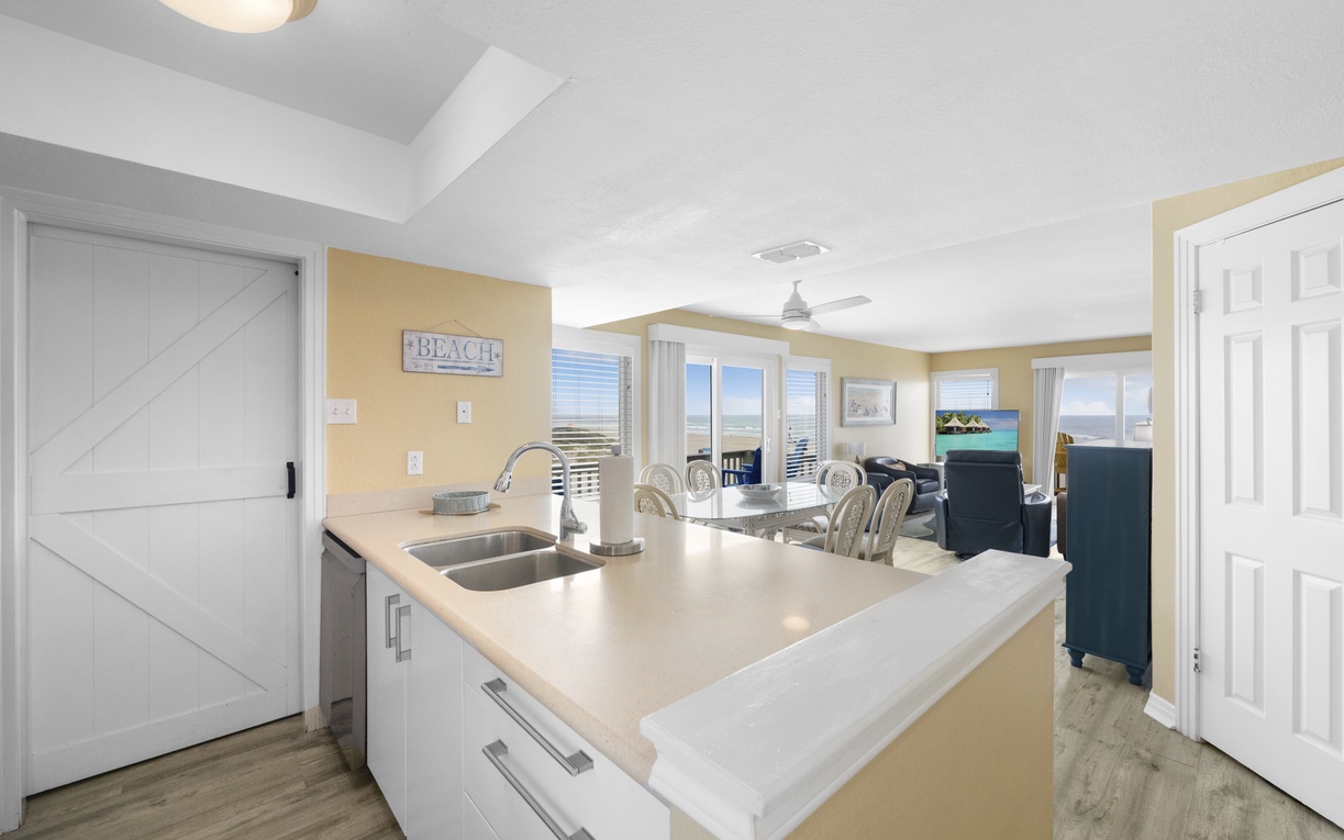 Your bright, open kitchen flows seamlessly into the dining area, featuring gleaming countertops and modern appliances for effortless meal prep.