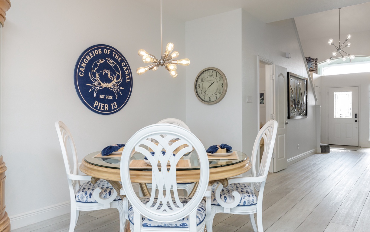 Your elegant dining space features coastal charm with stylish seating and warm lighting for memorable meals together.