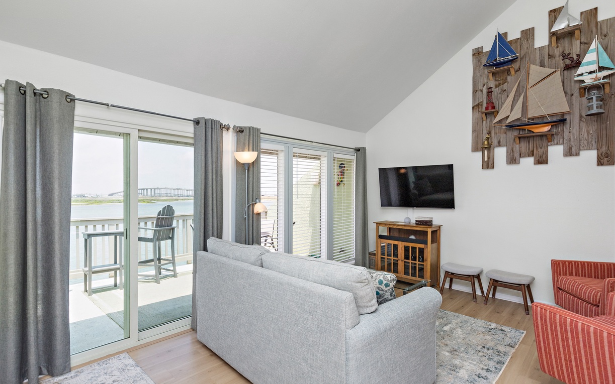 Sink into coastal comfort in your bright living room, where nautical touches and water views create your perfect lakeside retreat.