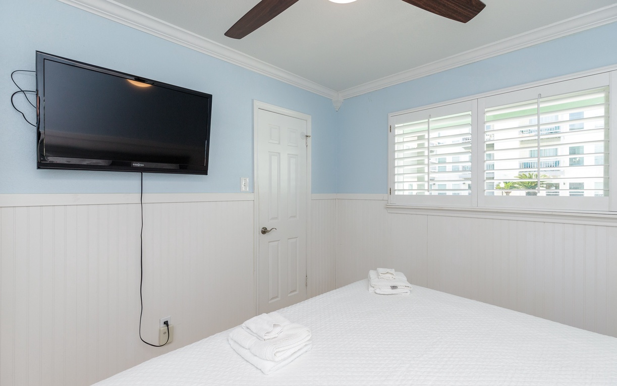 Relax in your bright bedroom with soft blue walls, crisp white linens, and king size bed for cozy evenings in.