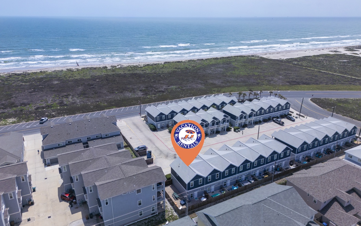Coastal vacation rental community featuring modern townhomes just steps from pristine sandy beaches and rolling ocean waves.