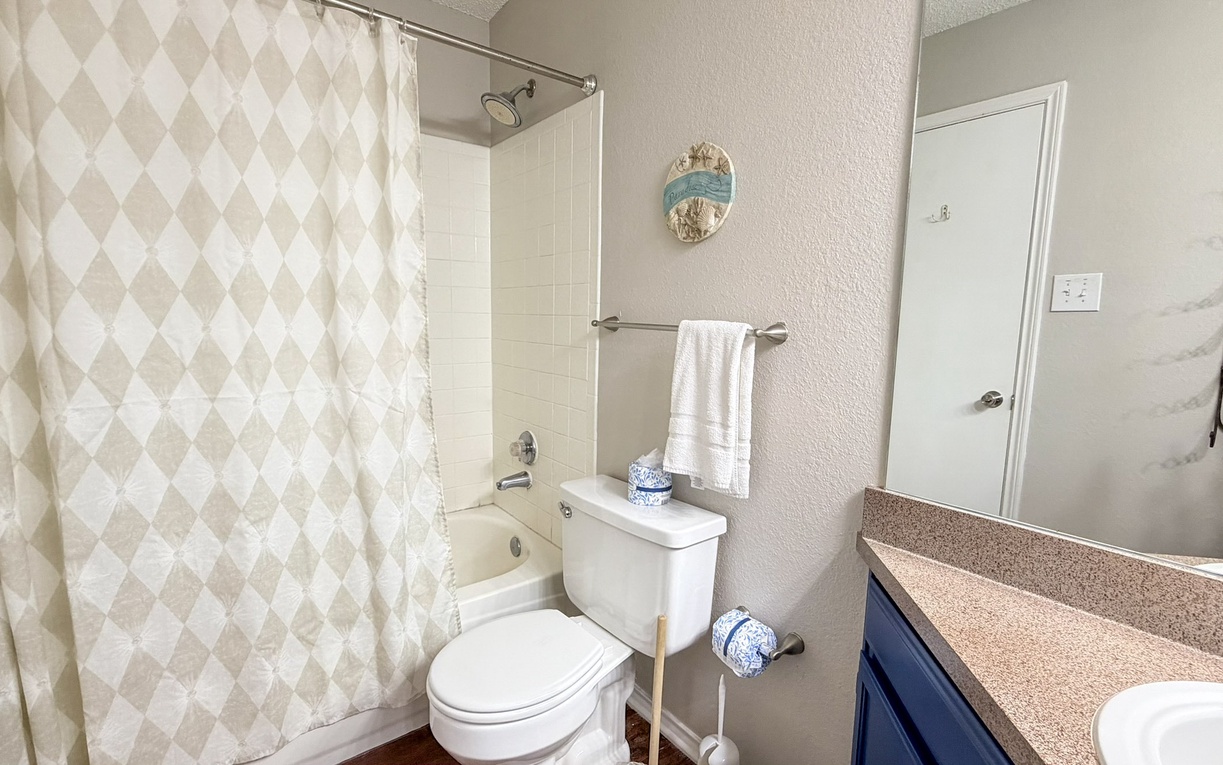 Refresh in your private bathroom featuring a full tub-shower combo, fresh towels, and thoughtful coastal touches that make you feel right at home.