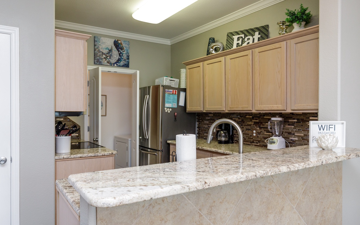 Your spacious kitchen features granite countertops, stainless appliances, and warm wood cabinets where you'll love preparing meals and morning coffee together.