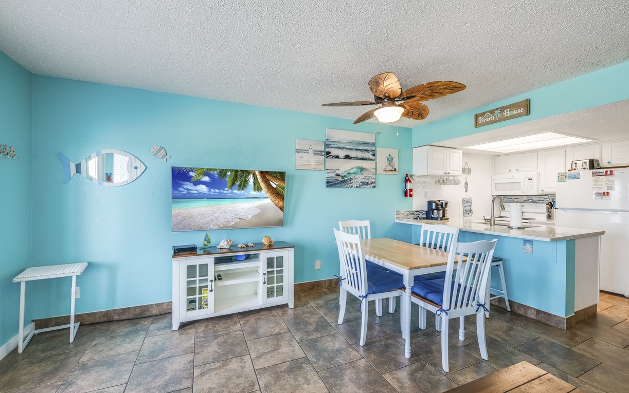 Picture yourself enjoying morning coffee in this cheerful coastal space, where ocean breezes meet beach-inspired décor. Your open dining and kitchen area invites relaxed meals and easy conversation.