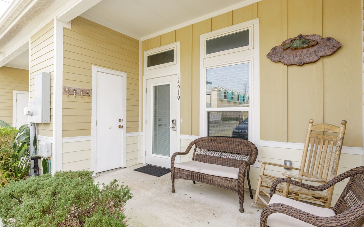Unwind on your private porch with comfortable wicker seating and gentle ocean breezes - the perfect spot for morning coffee.