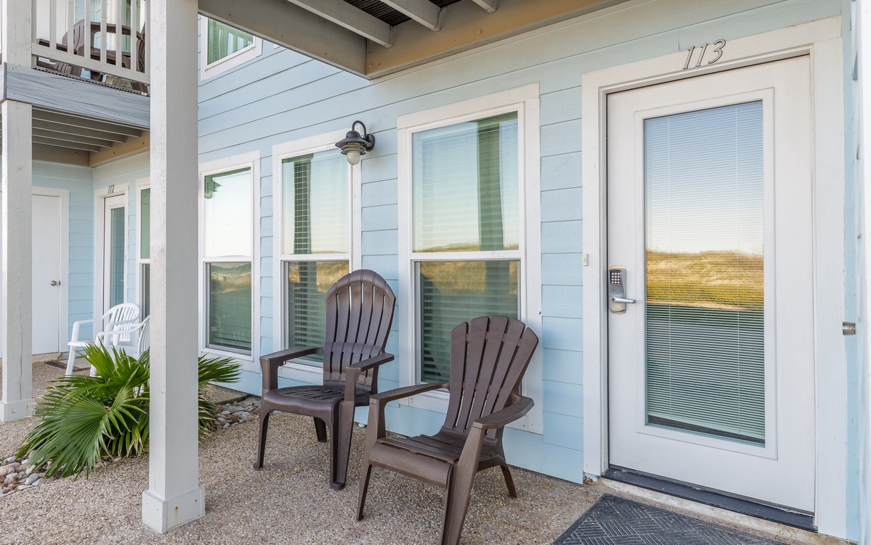 Charming coastal entrance with private seating where you can unwind and enjoy peaceful moments on your own covered patio.