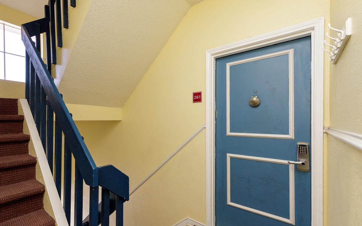 Your bright blue door marks the entrance to your home away from home, complete with secure keypad access for easy check-in.