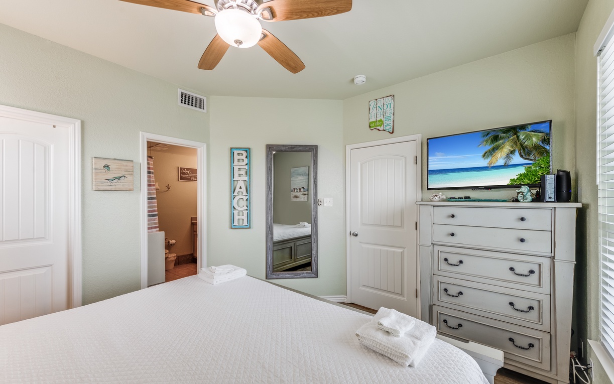 Drift off to sleep in your bright, beachside bedroom with coastal charm and tropical TV views to set the perfect vacation mood.