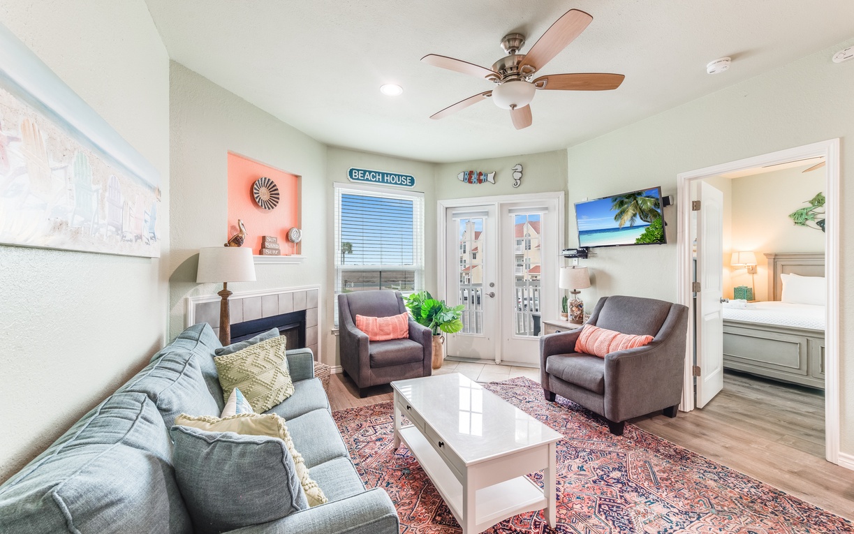 Sink into plush seating while ocean breezes flow through your bright living room, complete with coastal charm and modern comforts.